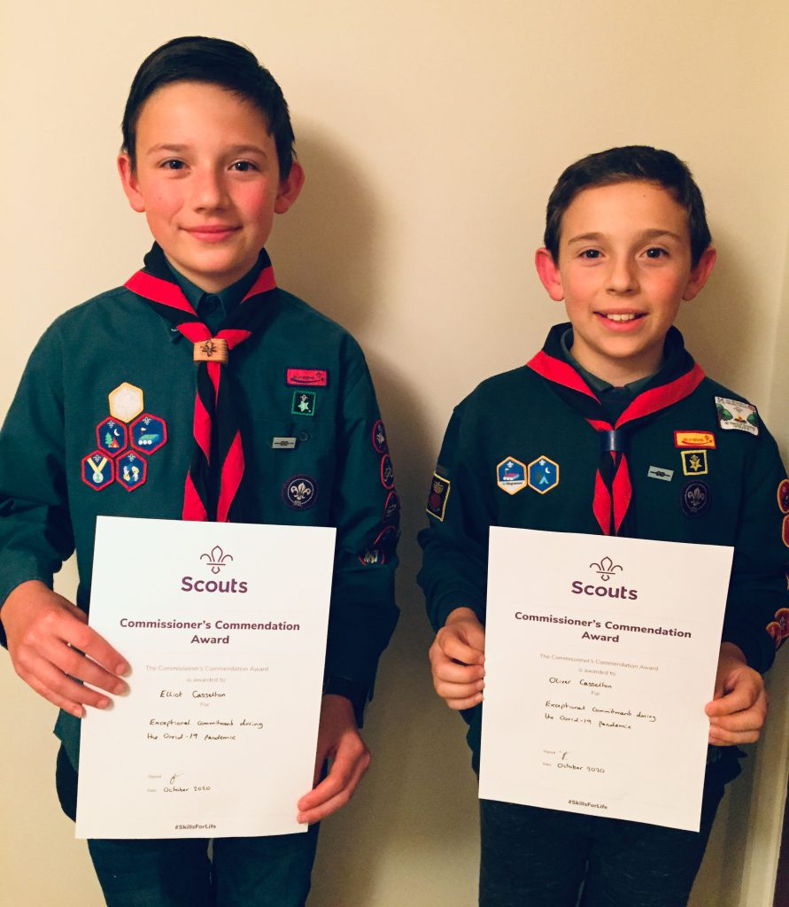 Elliot (left) and Oliver (right) holding their awards gained for their 26 musical charity performances.