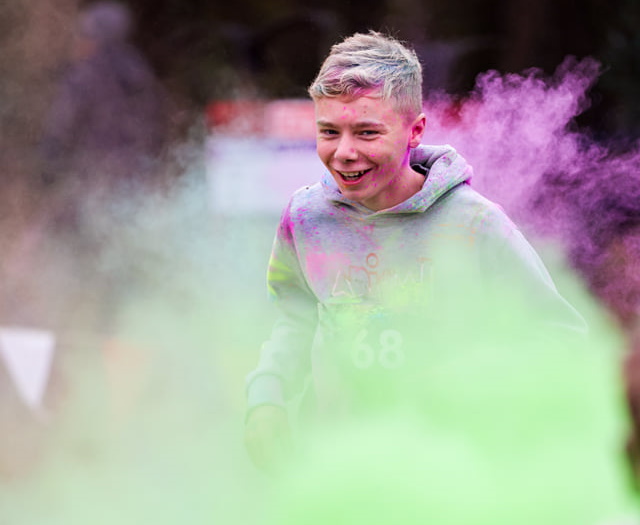 A scout being covered in paint at the Mud Run