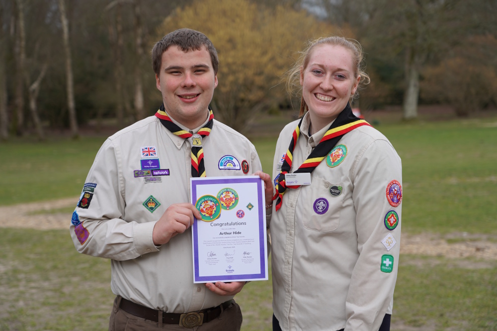Arthur being presented his award by Chloe, Network Lead for Hampshire Scouts.